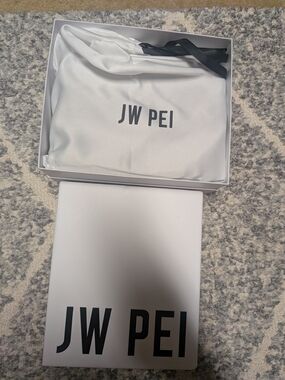 JW PEI White Crossbody Pouch with Black Strap